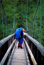 Hikers on a Footbridge Across Pemigewasset River, New Hampshire | Obraz na stenu