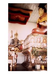 A Young Girl Praying in Front of a Giant Buddha Statue | Obraz na stenu