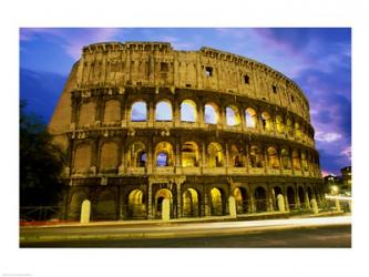 Low angle view of the old ruins of an amphitheater lit up at dusk, Colosseum, Rome, Italy | Obraz na stenu