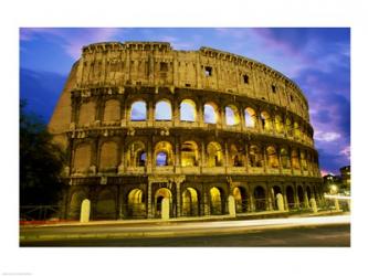 Low angle view of the old ruins of an amphitheater lit up at dusk, Colosseum, Rome, Italy | Obraz na stenu