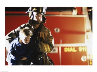 Close-up of a firefighter carrying a boy | Obraz na stenu