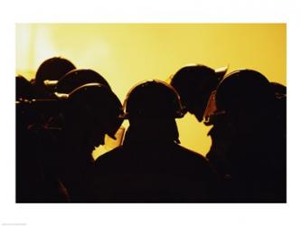 Rear view of a group of firefighters looking down | Obraz na stenu