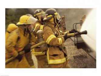 Side profile of a group of firefighters holding water hoses | Obraz na stenu