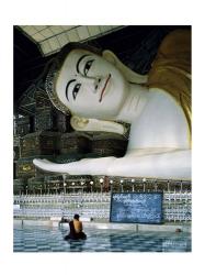 Monk Sitting in Front of a Buddha Statue | Obraz na stenu