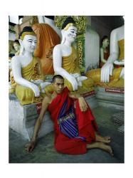 Monk Sitting in Front of a Buddha Statue | Obraz na stenu