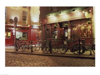 Bicycles parked in front of a restaurant at night, Dublin, Ireland | Obraz na stenu