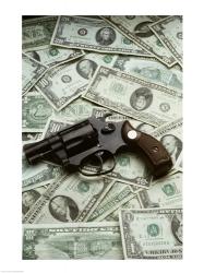 Close-up of a handgun with paper currency | Obraz na stenu