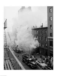 New York City, Fire on East 47th Street, with fire engines shooting water on burning building | Obraz na stenu