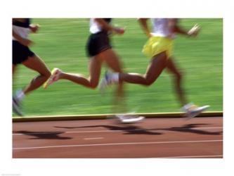 Low section view of male athletes running on a running track | Obraz na stenu