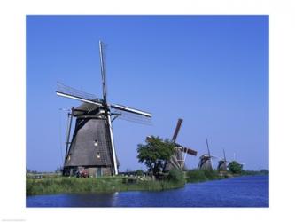Windmills along a river, Kinderdike, Amsterdam, Netherlands | Obraz na stenu