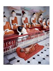 Monk Sleeping in Front of Buddha Statues | Obraz na stenu