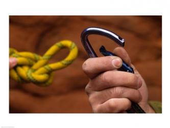 Close-up of human hands holding a carabiner and rope | Obraz na stenu