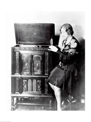 Young woman sitting beside an RCA Radio-Phonograph and Home Recorder | Obraz na stenu