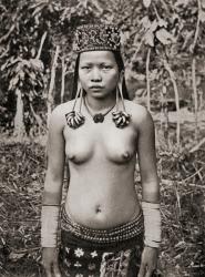 A Kenyah woman from Sarawak, Borneo, Malaysia, with distended ear lobes. The ear lobes are pierced at an early age and when the hole is sufficiently large a copper ring is inserted and eventually others are added until the the lobe reaches to below the co | Obraz na stenu