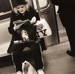 Woman reading on a subway with a Marilyn Monroe purse and an 'I Love New York' bag, 2004 (b/w photo) | Obraz na stenu