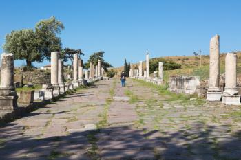 Asklepieion (also spelled Asclepieion, Asclepion, Asklepion, Asclepeion), near Bergama, Izmir Province, Turkey. A visitor strolls along the main street, known as the Sacred Way, which leads to and from the ancient medical centre. | Obraz na stenu