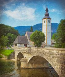 Triglav National Park, Upper Carniola, Slovenia. The church of St. John (Cerkev sv Janeza) at the village of Ribcev Laz, at the eastern end of Lake Bohinj. | Obraz na stenu