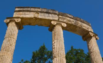 Olympia, Peloponnese, Greece. Ancient Olympia. The Philippeion, 4th century BC. Closeup of columns and capitals of a circular building of the Ionic order, donated by Philip II of Macedon after the battle of Chaeronea. The building was completed by his son | Obraz na stenu