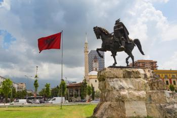 Tirana, Albania. Skanderbeg Square with monument to Skanderbeg, real name George Castriot, 1405  1468. Albanian national flag. Et'hem Bey mosque in background. The mordern building behind the mosque is the 85 meter high TID Tower. The tower was designed  | Obraz na stenu