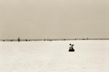 Man sitting on a beach playing his horn, 2004 (b/w photo) | Obraz na stenu