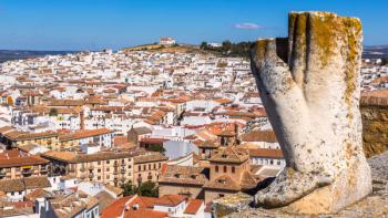 Antequera, Malaga Province, Andalusia, southern Spain. Remains of statue on top of Arco de los Gigantes (Arch of the Giants), with the town beyond. The building on the hill in the far distance is the Ermita de la Veracruz (photo) | Obraz na stenu