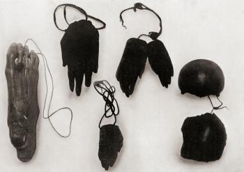 Human ornaments including a dried and smoked foot, hands and portions of a skull of a New Guinea man, worn by grieving relatives of the deceased as a memorial. After a 19th century photograph. From Customs of The World, published c.1913. | Obraz na stenu