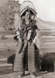 A woman from western Tibet wearing traditional dress. The headdress is covered with pearls, coral, turquoise and other uncut precious stones and glass beads. Each stone has a special protective property against evil spirits. The necklace carries an amulet | Obraz na stenu